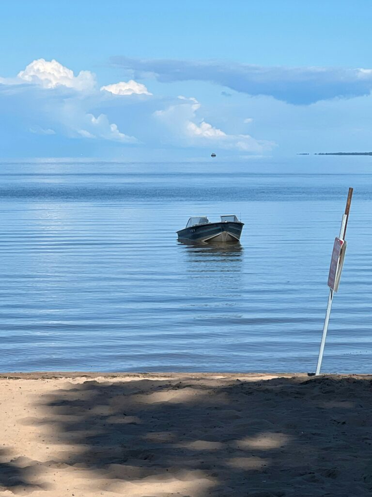 A picture showcasing a boat on the shores of lake malawi