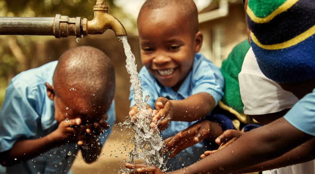 Children playing with clean water at Kalambo Primary School